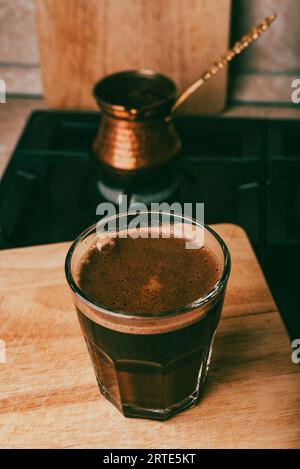 Bere il caffè turco bollito nella tradizionale pentola di rame Foto Stock