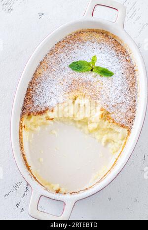 Budino di limone al forno guarnito con zucchero a velo e menta Foto Stock