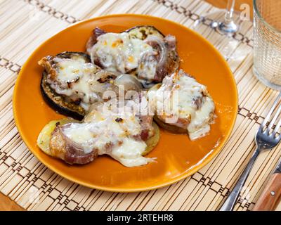 Carne al forno su melanzane e patate sotto formaggio Foto Stock