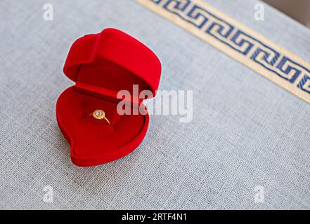 anello in oro con cuore rosso Foto Stock