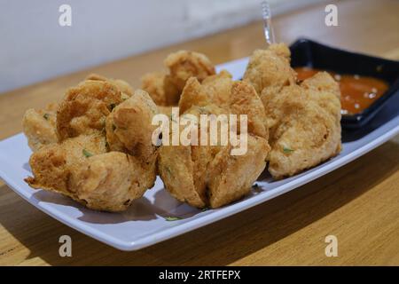 Scatto a fuoco selettivo di un piatto di polpette fritte con salsa al peperoncino Foto Stock