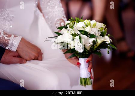 Una sposa con un abito da sposa bianco con bouquet bianco. Saint Amour. Francia. Foto Stock
