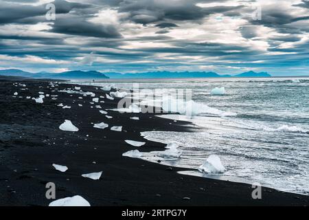 Famosa spiaggia Diamond con iceberg che si scioglie sulla spiaggia di sabbia nera vicino alla laguna del ghiacciaio Jokulsarlon in estate nel sud dell'Islanda Foto Stock