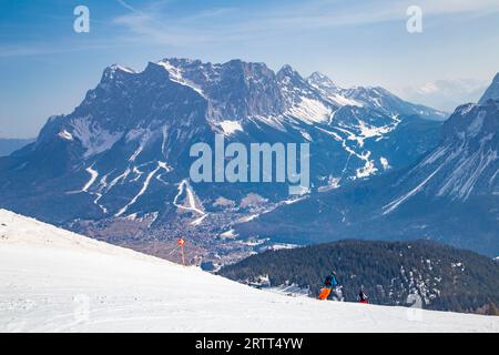 Sciatori sulla pista panoramica con vista sul comprensorio sciistico Zugspitze, Grubigstein, Lermoos, Tirolo Foto Stock