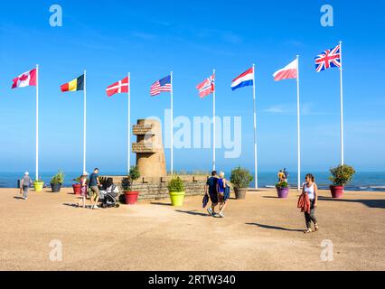 I turisti passeggiano per il monumento Signal a Bernières-sur-Mer, Francia, eretto nel 1950 sul sito dello sbarco in Normandia della seconda guerra mondiale di Juno Beach. Foto Stock