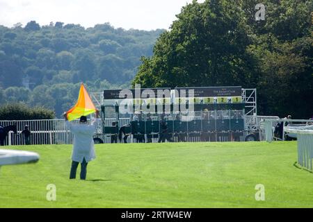 Epsom, Surrey, Regno Unito. 14 settembre 2023. Corse di fine estate a Epsom Downs. OPS: Flag man indica l'inizio del Bohle Centenary handicap (Classe 4) mentre l'ultimo cavallo entra nelle bancarelle credito: Motofoto/Alamy Live News Foto Stock