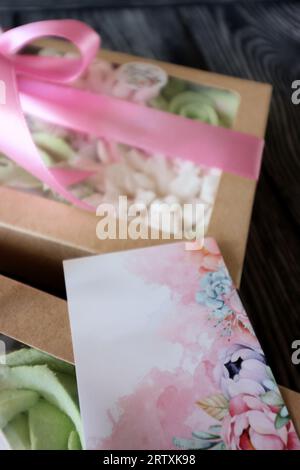 Due scatole con marshmallow. Fiori di Zephyr. Marshmallow fatti in casa in una confezione regalo di carta. La scatola è legata con un nastro legato a un arco. Etichetta per la t Foto Stock