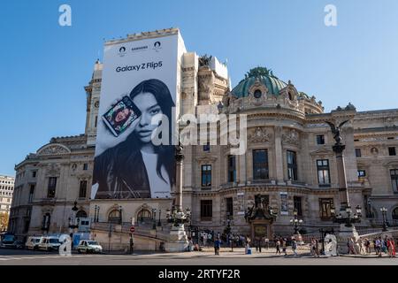 Grande cartellone pubblicitario Samsung Galaxy Z Flip5 che copre l'impalcatura dei lavori di ristrutturazione sulla facciata del Teatro dell'Opera di Parigi Foto Stock