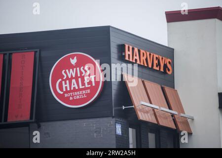 Ristorante HARVEYS e banner SWISS CHALET. Ristorante canadese specializzato in hamburger, panini, involtini, poutine, bevande surgelate e molto altro. Foto Stock