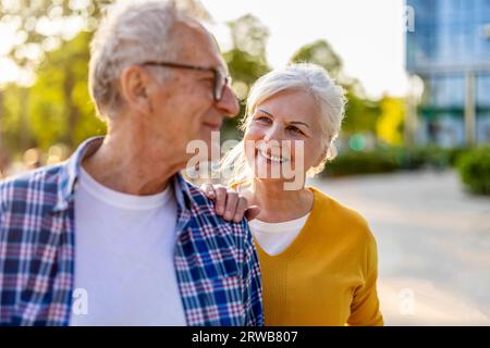 Ritratto di una felice coppia anziana in una strada cittadina in una giornata di sole Foto Stock