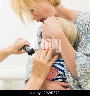 Bambino bambino bambino bambino in esame dal suo medico pediatra durante un controllo medico standard in presenza e comfort di sua madre. Sanità pubblica nazionale e cura dei bambini koncept Foto Stock