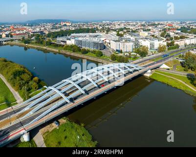 Cracovia, Polonia. Ponte sospeso Kotlarski con autostrada cittadina a quattro corsie, tram, piste ciclabili rosse e passaggi pedonali sul fiume Vistola. Città vecchia con Wawel Foto Stock