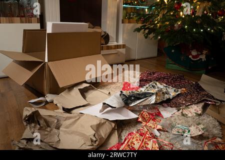 E' la vigilia di Natale. I regali sono stati scartati. Nel soggiorno di Natale c'è un caos di confezionamento di carta e scatole sotto la tr di Natale Foto Stock