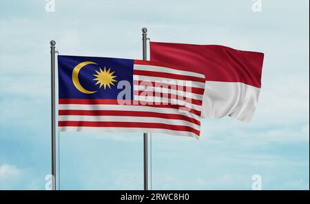 Bandiera indonesiana e bandiera malese che sventolano insieme sul cielo blu, concetto di cooperazione tra due paesi Foto Stock