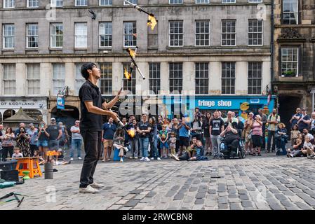 Street performer giocoliere di torce di fuoco, Edinburgh Festival Fringe, Royal Mile, Scozia, Regno Unito Foto Stock