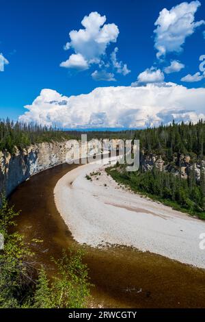 Lo splendido fiume Trout attraversa la Foresta Boreale mentre Thunderheads costruisce nei territori del Nord-Ovest, NT, Canada Foto Stock