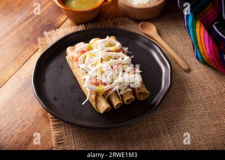 Taco Dorados. Il piatto messicano, noto anche come flautas, consiste in una tortilla di mais arrotolata con un po' di ripieno, comunemente pollo o manzo o opzione vegetariana Foto Stock