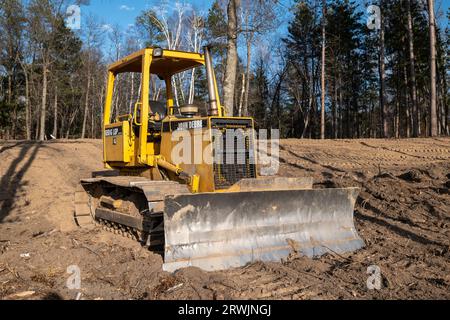 CROW WING CO, MN - 10 MAGGIO 2023: Il vecchio apripista John Deere con lama anteriore e potenza idraulica, parcheggiato su un nuovo terreno di cantiere edile Foto Stock