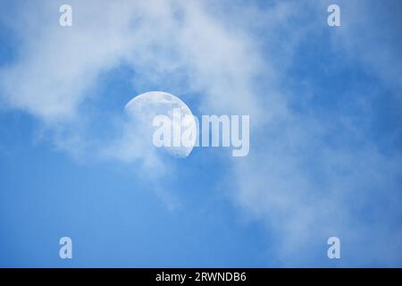 La Luna è nel cielo nuvoloso di giorno Foto Stock