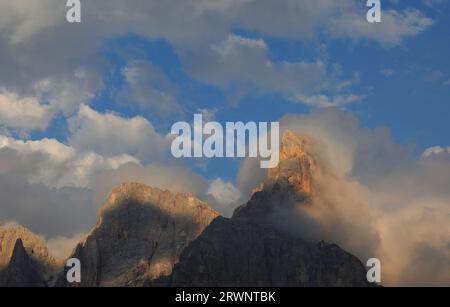 Nuvole e alta montagna chiamata CIMON DELLA PALA al tramonto nell'Italia settentrionale Foto Stock