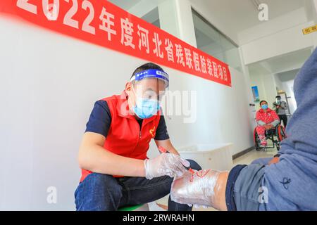 LUANNAN COUNTY, Cina - 13 maggio 2022: Personale che installa arti artificiali per disabili, Cina settentrionale Foto Stock