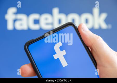 Stoccarda, Germania - 20 luglio 2023: Mano che regge un telefono cellulare con il logo Facebook schermo del social media computer a Stoccarda, Germania. Foto Stock