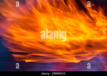 Fiamme arancioni e gialle brillanti con bordi rosa e viola di sfondo Foto Stock
