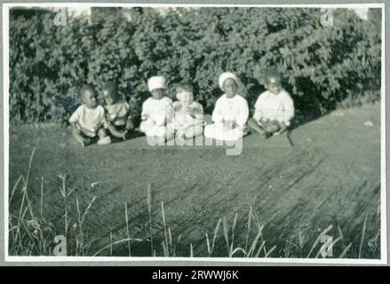 Una delle sette foto intitolate "Kabete Snaps". 1924.» Questa foto mostra la signora Bungey seduta sul sidecar di una motocicletta. Un'altra famiglia europea con due figli è accanto a lei, un ragazzo di circa 12 anni seduto sulla moto stessa. Foto Stock