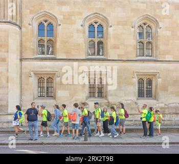 Gruppo di scolari turisti fuori dal prestigioso college di Corpus Christi presso l'università di Cambridge, Inghilterra. Foto Stock