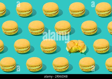 Macaron gialli disposti su sfondo colorato Foto Stock