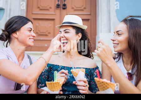 Amici felici che si divertono con i coni del gelato Foto Stock