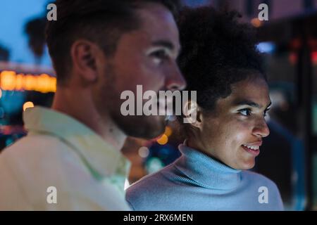 Giovane uomo e donna sorridenti al crepuscolo Foto Stock