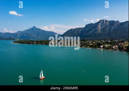 Austria, alta Austria, vista droni sul lago Mondsee, villaggio circostante e montagna Schafberg Foto Stock