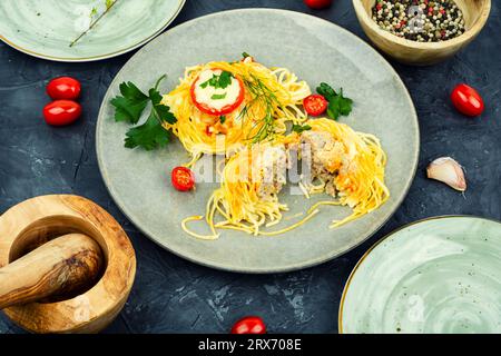 Nidi di spaghetti al forno con polpette e formaggio Foto Stock