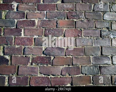 Vista frontale in formato integrale di un muro in mattoni a fuoco. Foto Stock