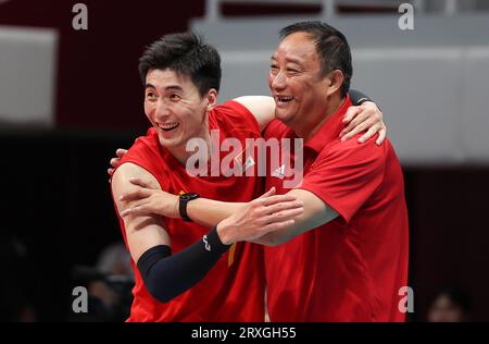 Hangzhou, provincia cinese di Zhejiang. 25 settembre 2023. Yu Yaochen (L) della Cina festeggia con il capo allenatore Wu Sheng durante la semifinale maschile di pallavolo tra Cina e Giappone ai 19 Giochi asiatici di Hangzhou, nella provincia dello Zhejiang, nella Cina orientale, il 25 settembre 2023. Crediti: Zhu Zheng/Xinhua/Alamy Live News Foto Stock