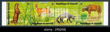 Striscia di 4 francobolli con animali africani. Burundi, 1975. Animali: Aonyx capensis, Redunca redunca, Civettictis civetta, Syncerus caffer nanus. Foto Stock