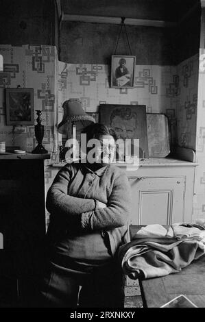 Anziana signora sedeva nella sala d'ingresso della sua casa vittoriana che è in attesa di demolizione durante la slum clearance di St Ann's, Nottingham, Inghilterra. Foto Stock