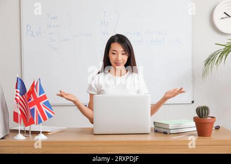 Insegnante di inglese che tiene lezioni di grammatica online in classe Foto Stock