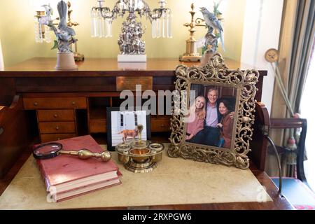Una foto dell'attuale governatore del Texas Greg Abbott, moglie Cecilia. E la figlia Audrey siede su una scrivania circondata da antiquariato e manufatti storici in un salotto della Governor's Mansion di Austin il 21 settembre 2023. ©Bob Daemmrich Foto Stock