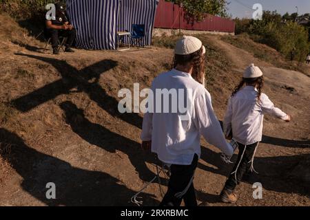 Uman, Ucraina. 17 settembre 2023. I pellegrini camminano davanti a una guardia di sicurezza sotto l'ombra di una croce Santa presso la tomba di Rabbi Nachman a Uman durante Rosh Hashanah, il capodanno ebraico. (Immagine di credito: © Svet Jacqueline/ZUMA Press Wire) SOLO USO EDITORIALE! Non per USO commerciale! Foto Stock