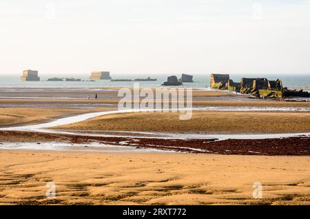 Resti di cassoni Phoenix sulla sabbia, utilizzati per costruire il porto di Mulberry a Gold Beach ad Arromanches, in Francia, dopo gli sbarchi in Normandia nella seconda guerra mondiale. Foto Stock