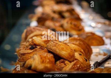 Pain au uvetta e altri prodotti da forno esposti in vendita, con una profondità di campo ridotta Foto Stock