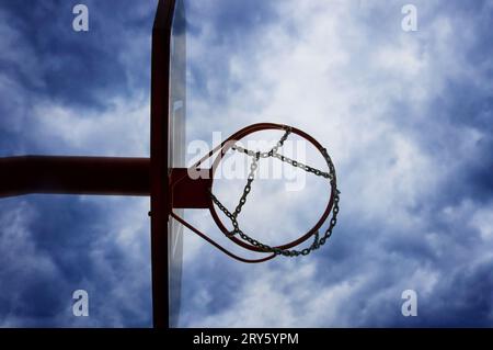 canestro da basket e rete con un cielo sopra, vista dall'angolo basso Foto Stock