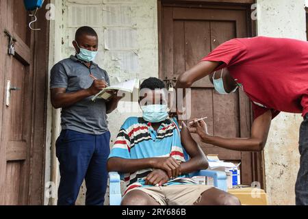 Un operatore sanitario, Yumbu Holela (a destra) inietta una dose di Sinopharm contro il Covid-19, durante la giornata di salute e nutrizione a Newala Foto Stock