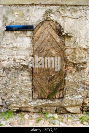 Ragged antica porta di legno con un lucchetto Foto Stock