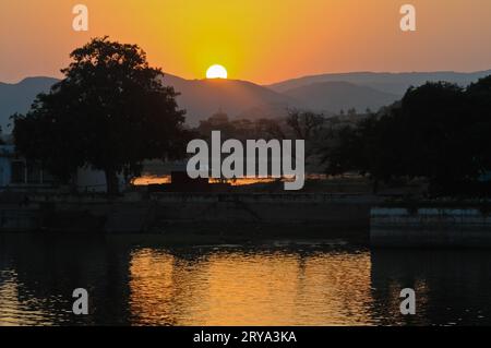 Tramonto sul lago Pichola e sulle Green Hills di Aravallis, Udaipur, India Foto Stock