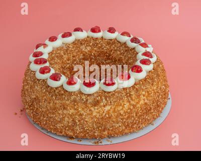 Il Frankfurter Kranz Cake, noto anche semplicemente come Kranz in Germania, è un classico e amato dessert tedesco. Torta su sfondo rosa. Foto Stock
