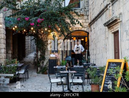 Korcula, Croazia, 17 settembre 2023: Vicolo con ristorante all'aperto nella città di Korcula, Croazia Foto Stock