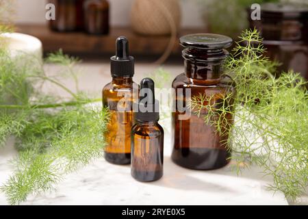 Olio essenziale di finocchio su bottiglie ambrate Foto Stock